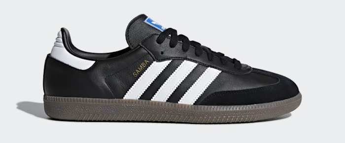 Side view of a black and white adidas shoe.